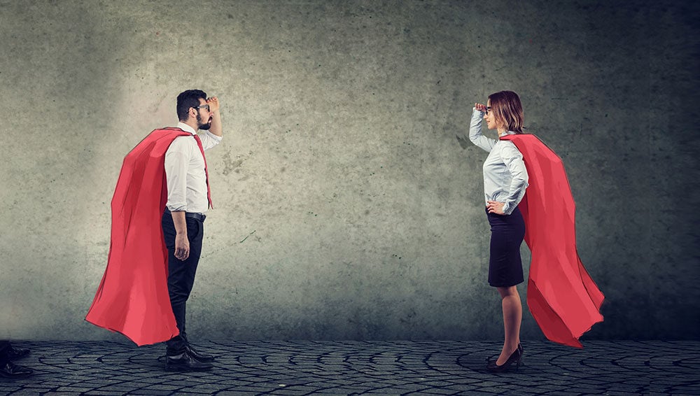 two business people in red capes