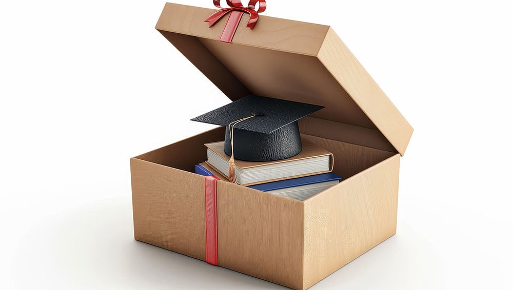 gift box with books and graduation cap inside